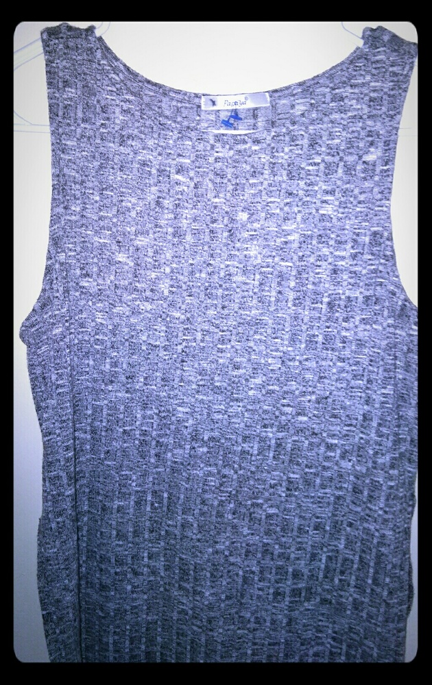 Sleeveless tank top with slits in the side.